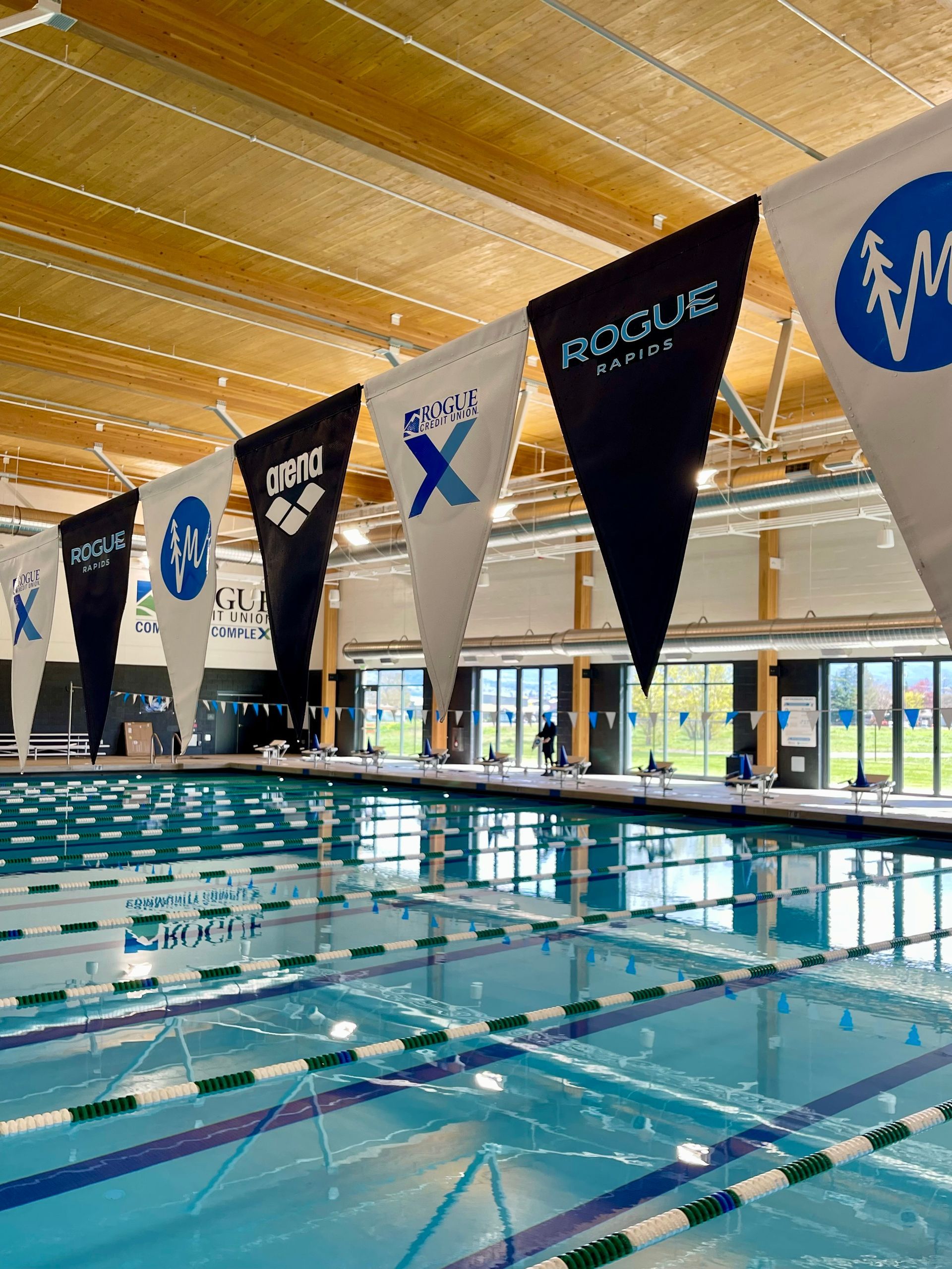 a group of people are swimming in a pool 