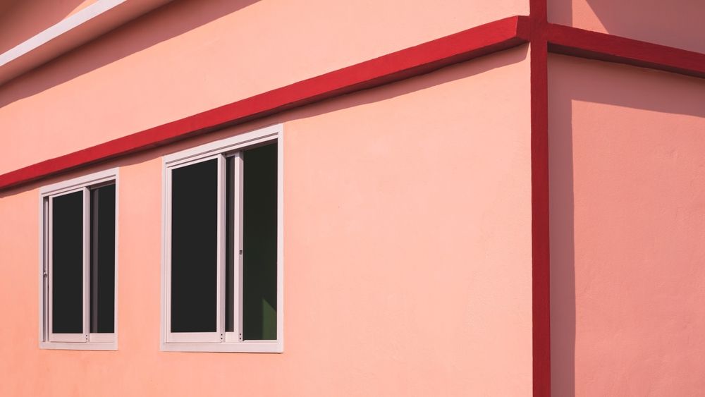 Building Exterior With Two Windows and Red Trim — Awesome Window Tint In Tuncurry, NSW
