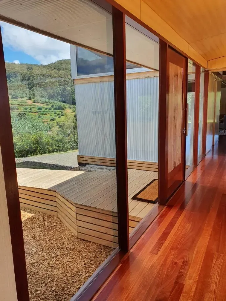 Modern wooden hallway with floor-to-ceiling windows  — Awesome Window Tint In Kempsey, NSW