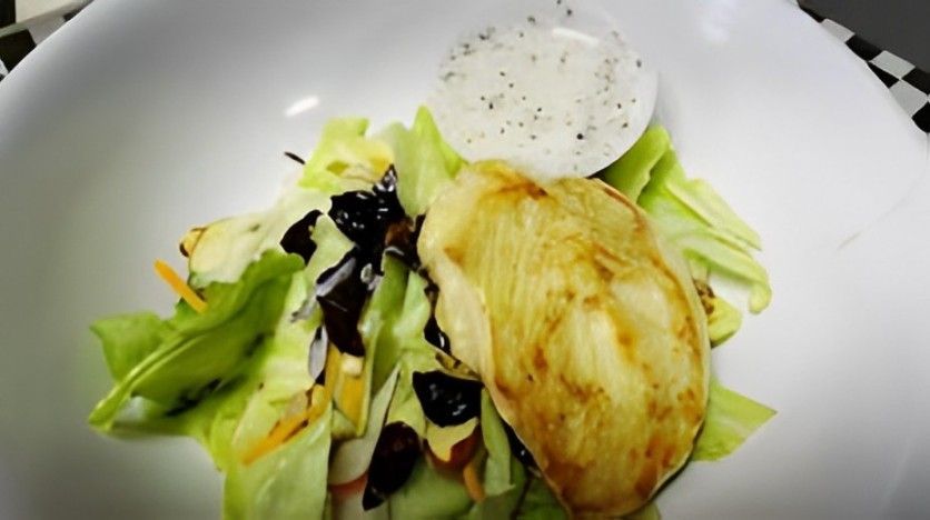 A close up of a salad in a white bowl