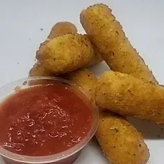 There is a bowl of ketchup next to a pile of mozzarella sticks.