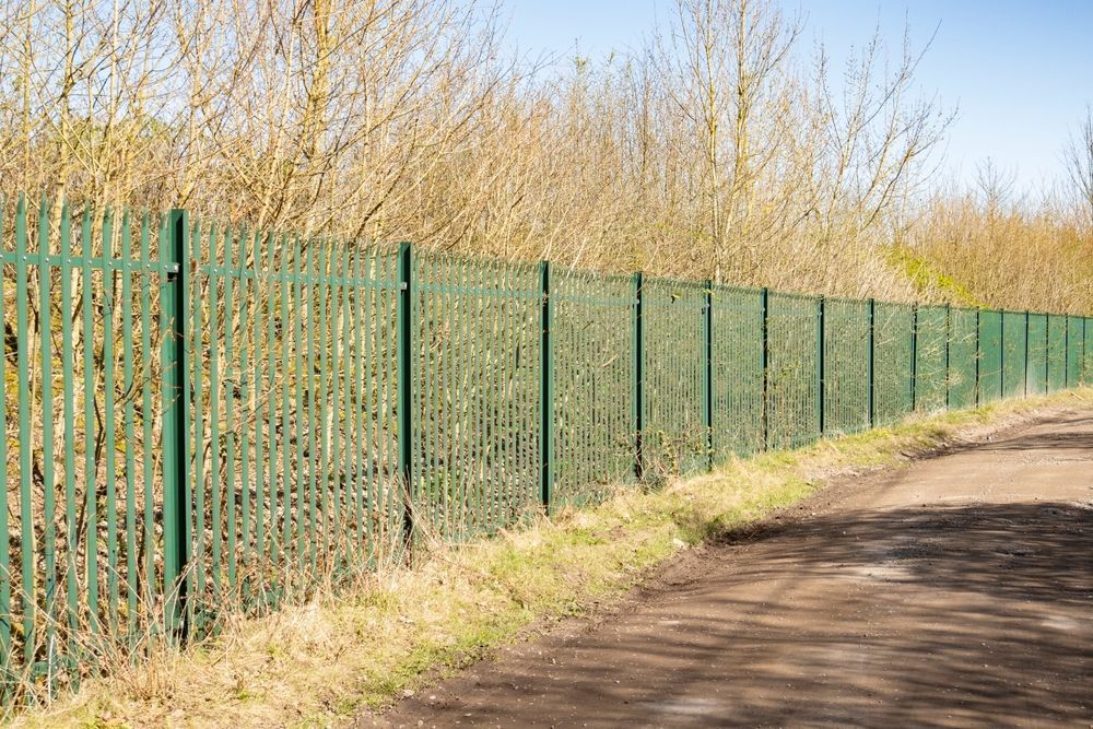 Green Metal Fence Bordering a Path — Fencer Steve In Laurieton, NSW