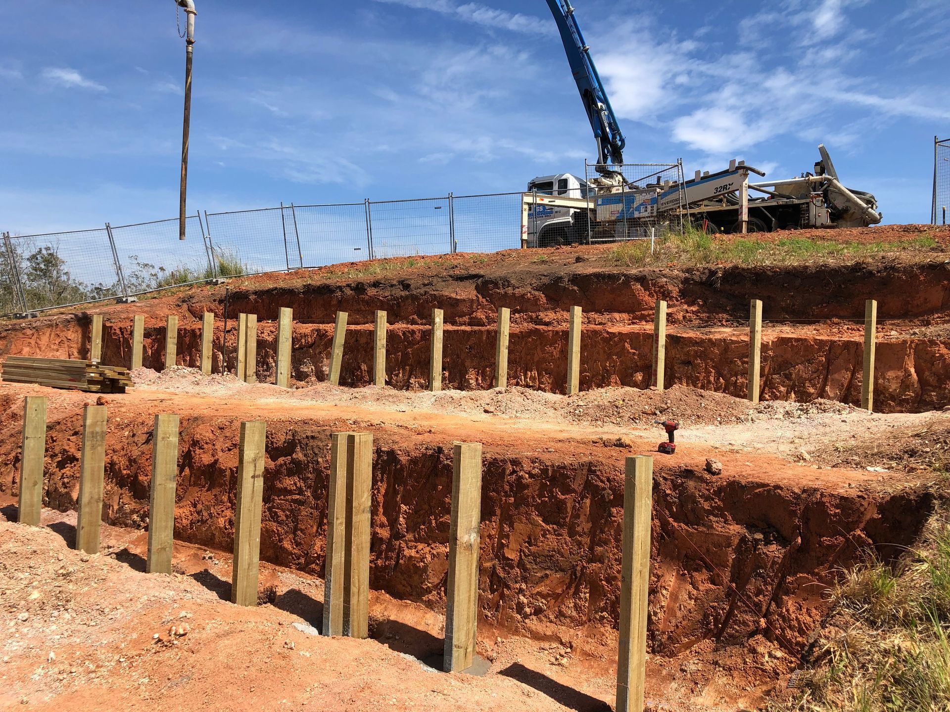Wooden Posts Supporting a Hillside, Construction Site — Fencer Steve In Wauchope, NSW