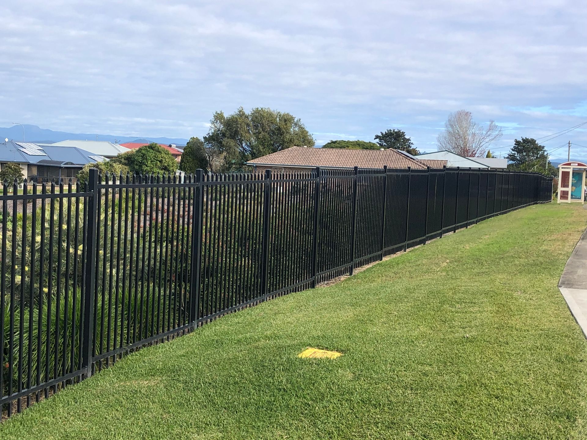 Black Metal Fence Along a Grassy Yard — Fencer Steve In Temagog, NSW
