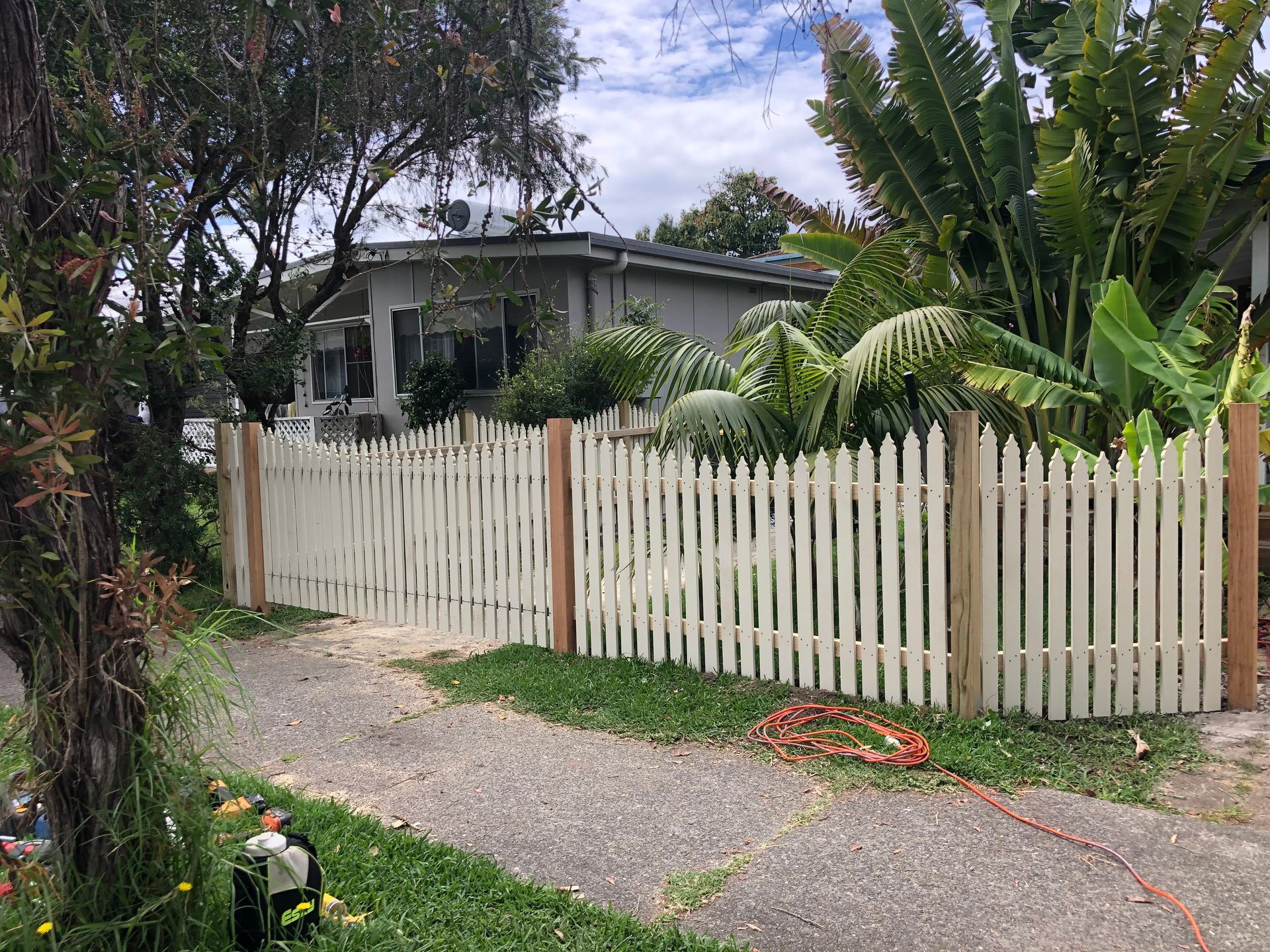 Brown Wooden Fence Surrounding a Green Lawn in Front of a House — Fencer Steve In Temagog, NSW