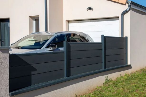 Gray Car Behind a Gray Horizontal Slat Fence in Front of a Light Beige House — Fencer Steve In Temagog, NSW