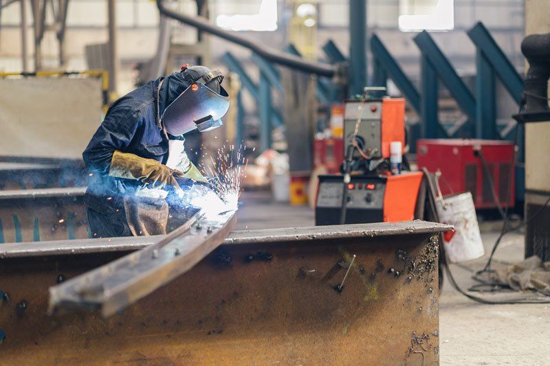 A welder preforming professional metal laser cutting in Melbourne