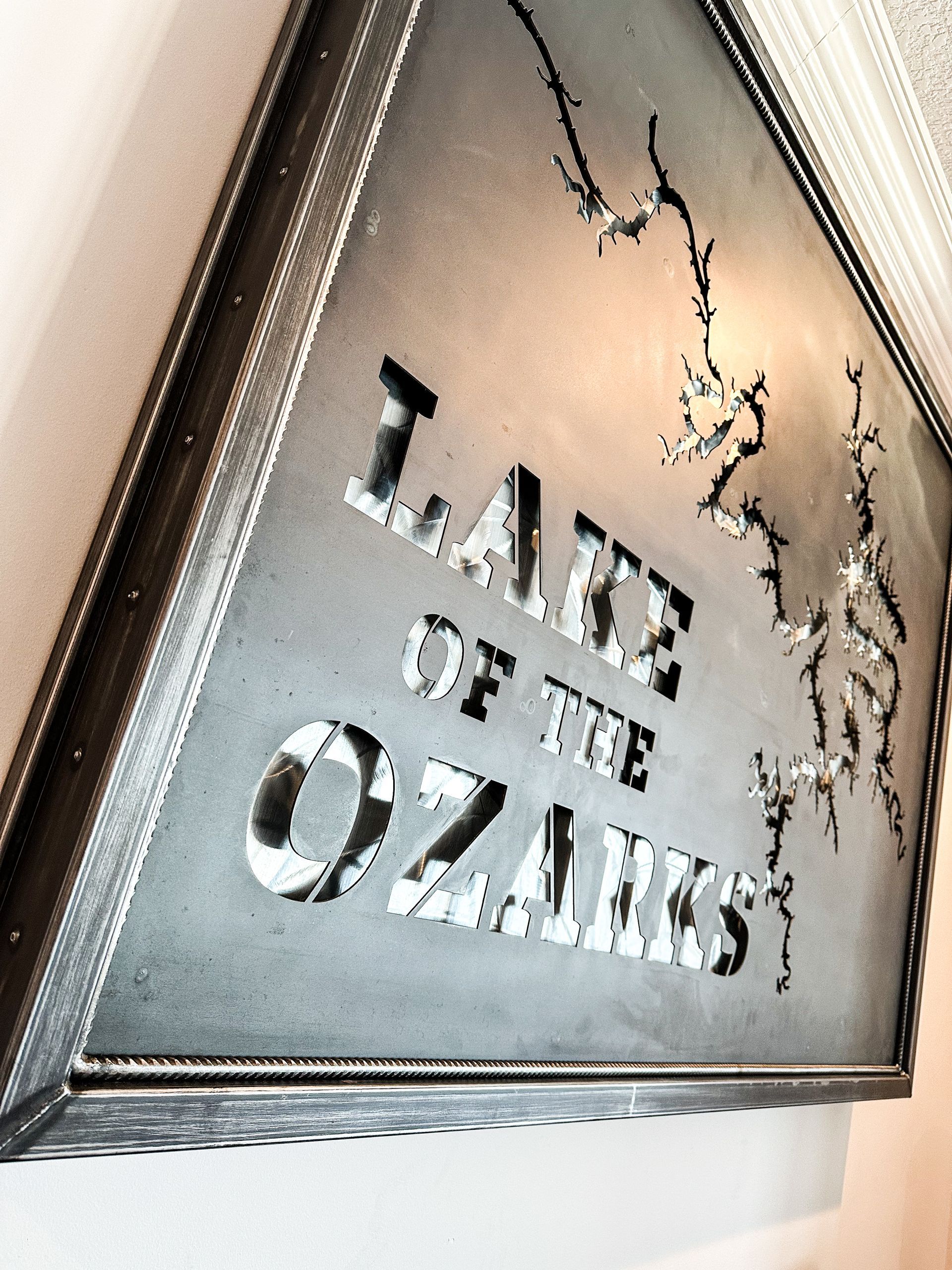 A Custom Steel Sign Detailing Lake Ozark on a Map With a Label. Call Merit Welding for Help