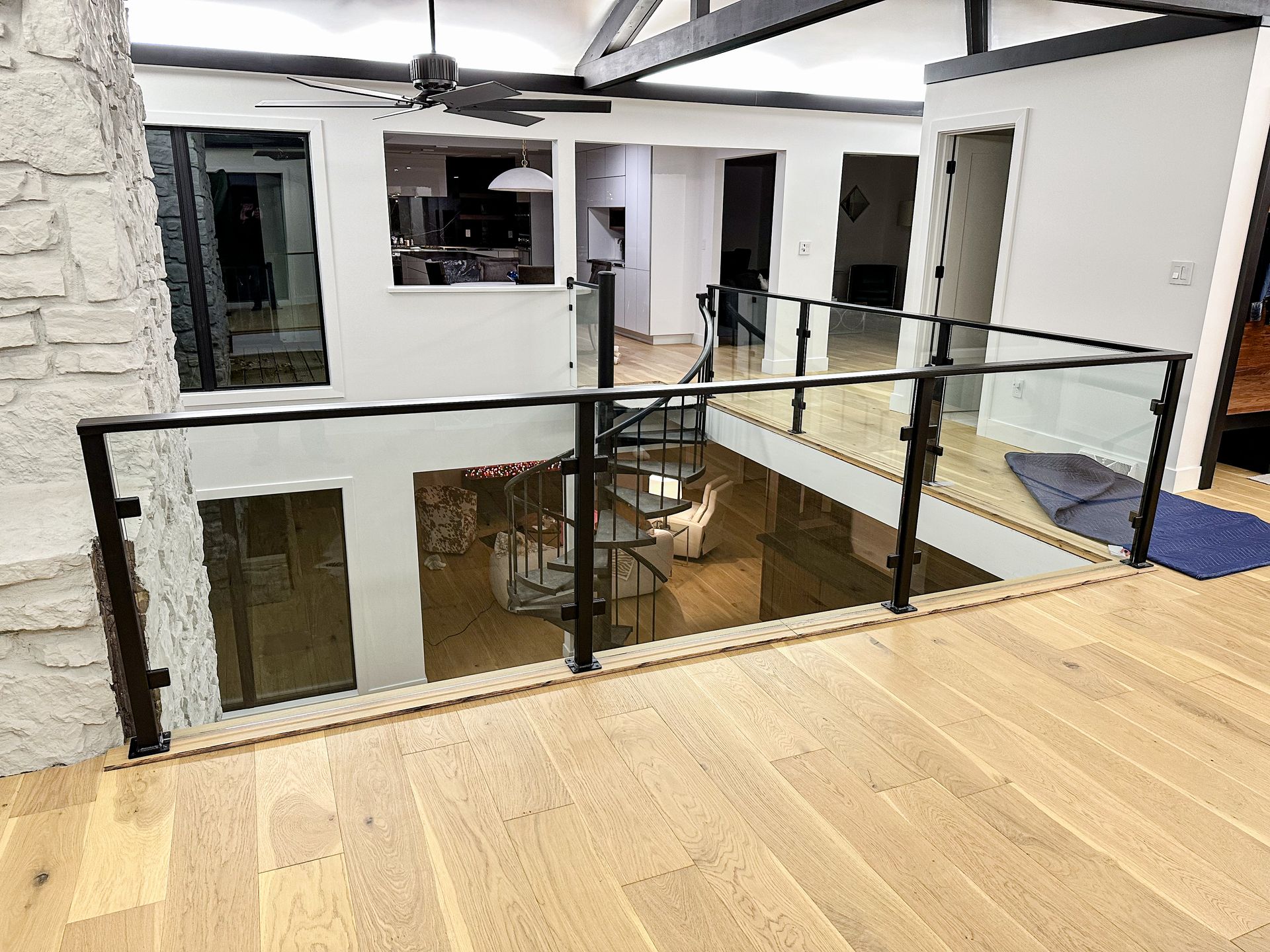 Merit Welding Adds Black Handrails Containing Glass Panels on the Second Floor of a Mid-MO Home