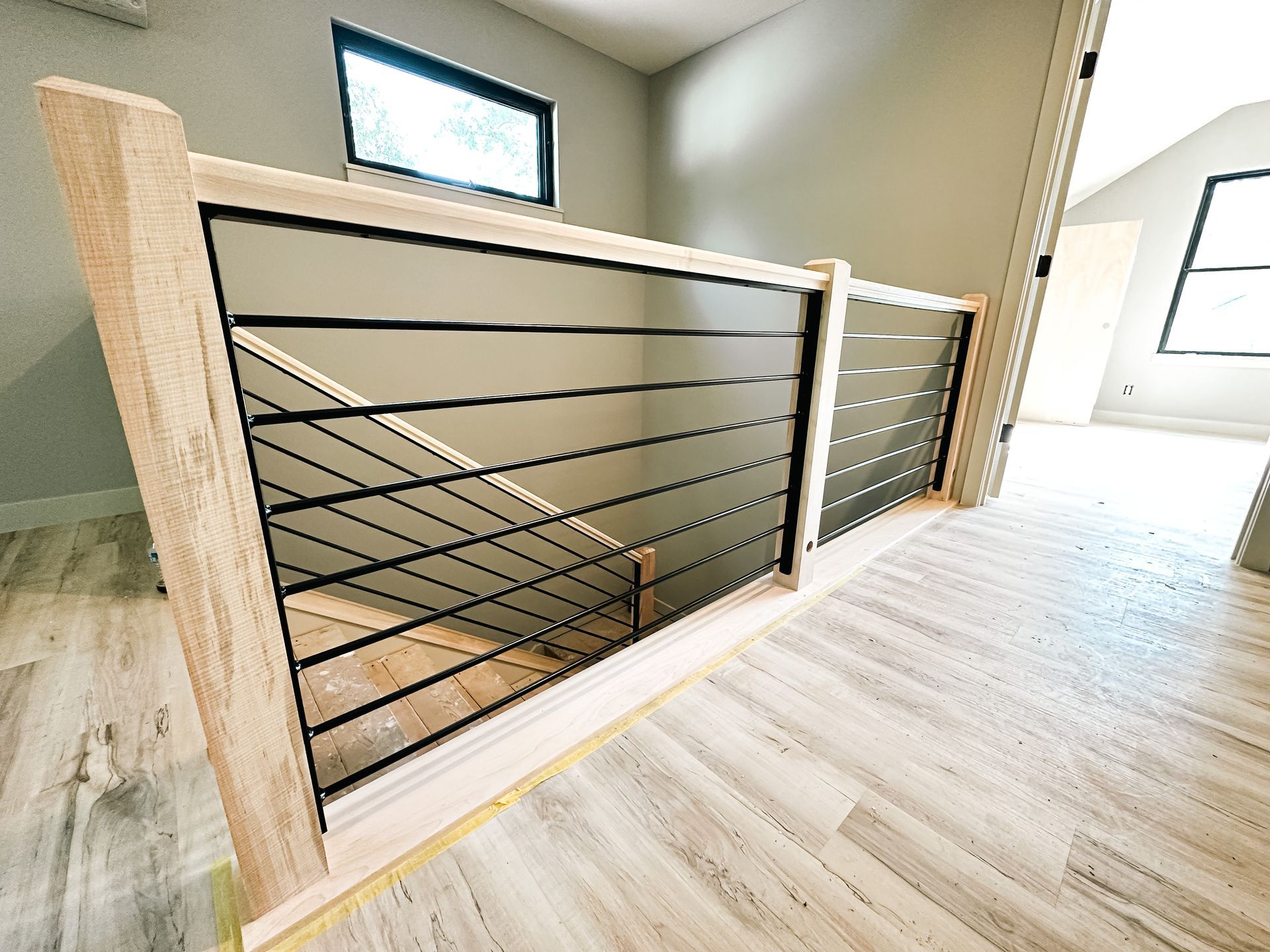 A Black & Wooden-Framed Railing & Handrail From Merit Welding in Mid-Missouri