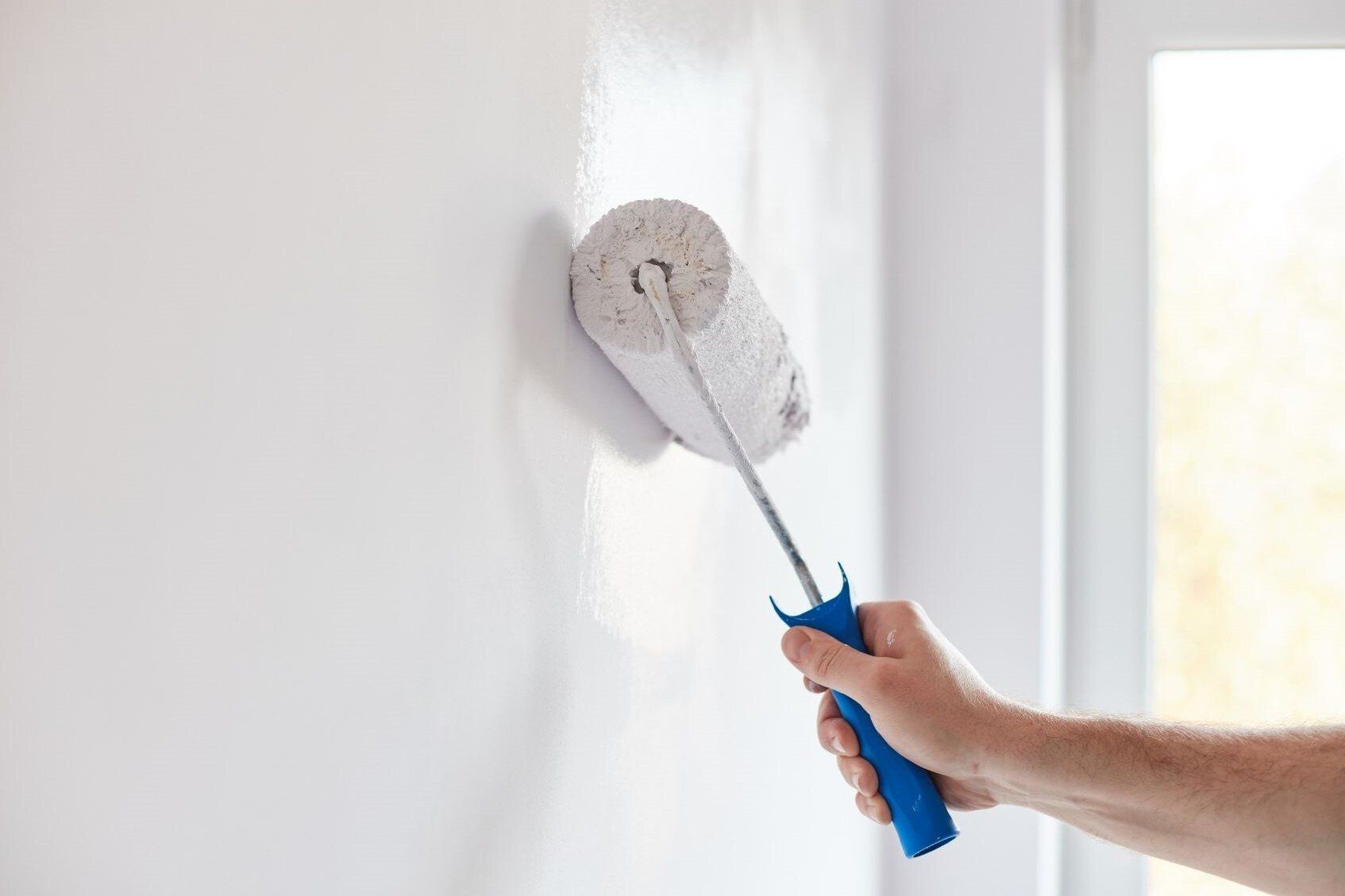White paint roller on wall