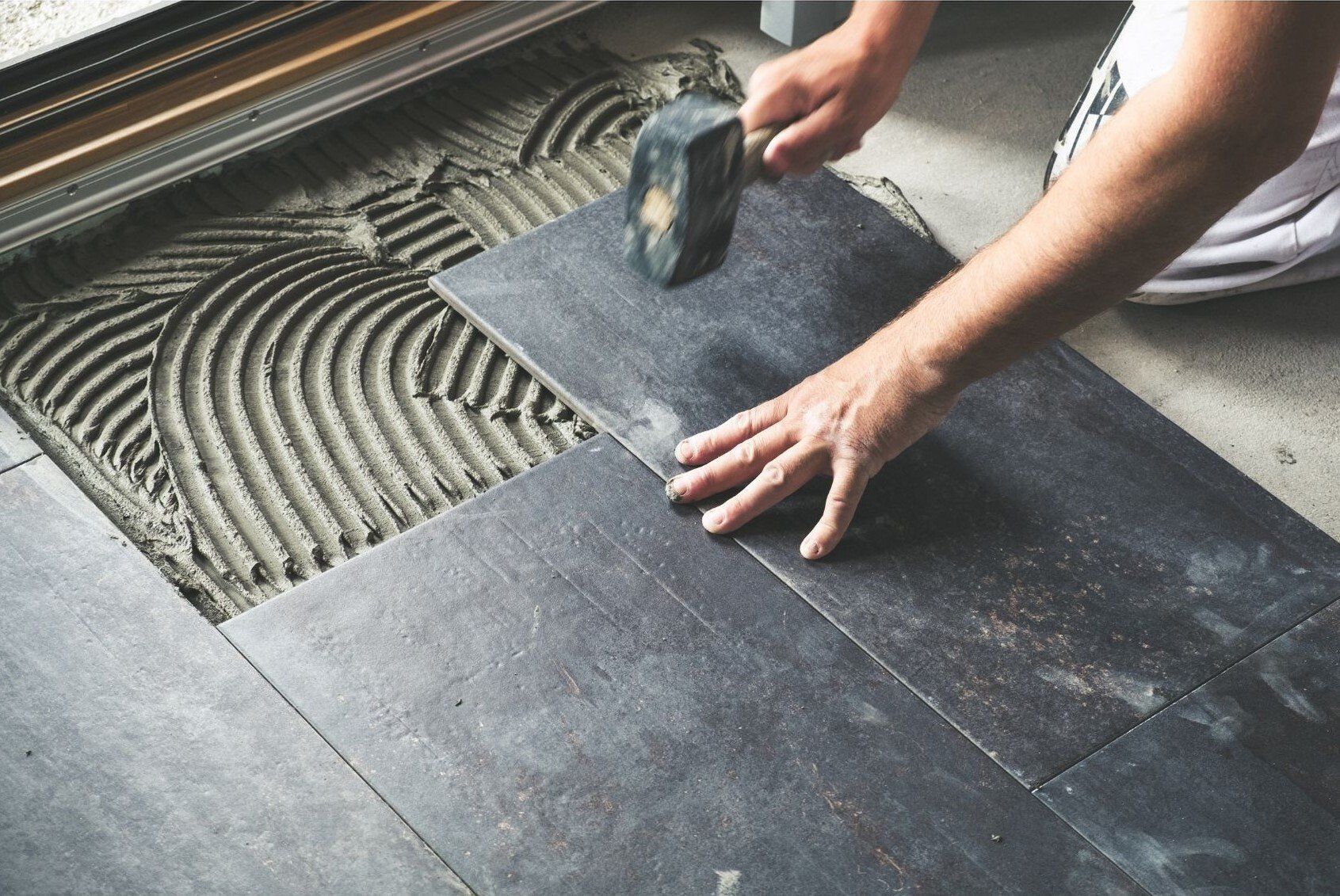 Dark Tile being installed on floor