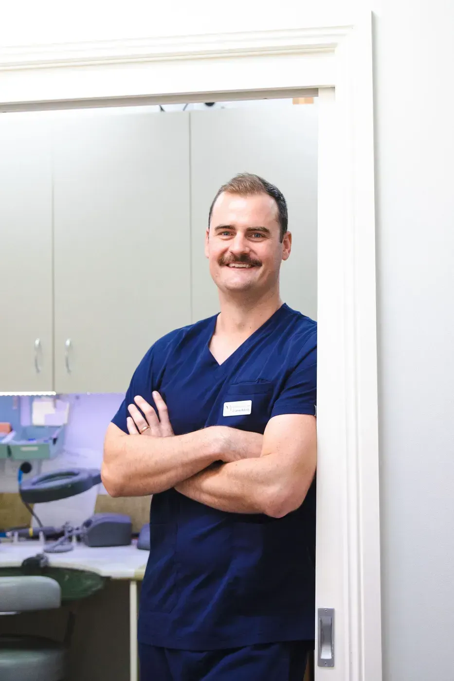 Man in Blue Scrubs — Maitland Dental Care in Maitland, NSW