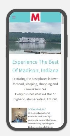 A cell phone with a website on it that says experience the best of madison indiana