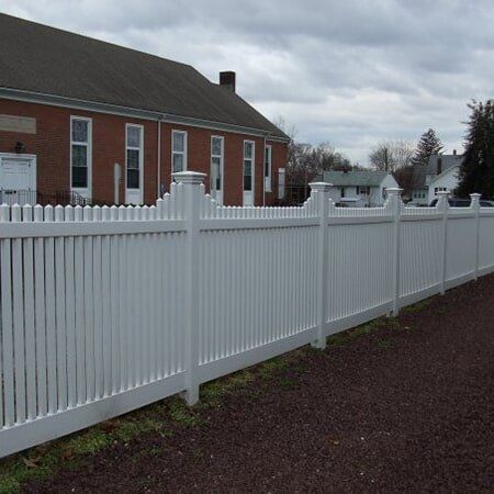 White Fence Beside a House - Ground Maintenance in Carneys Point, NJ