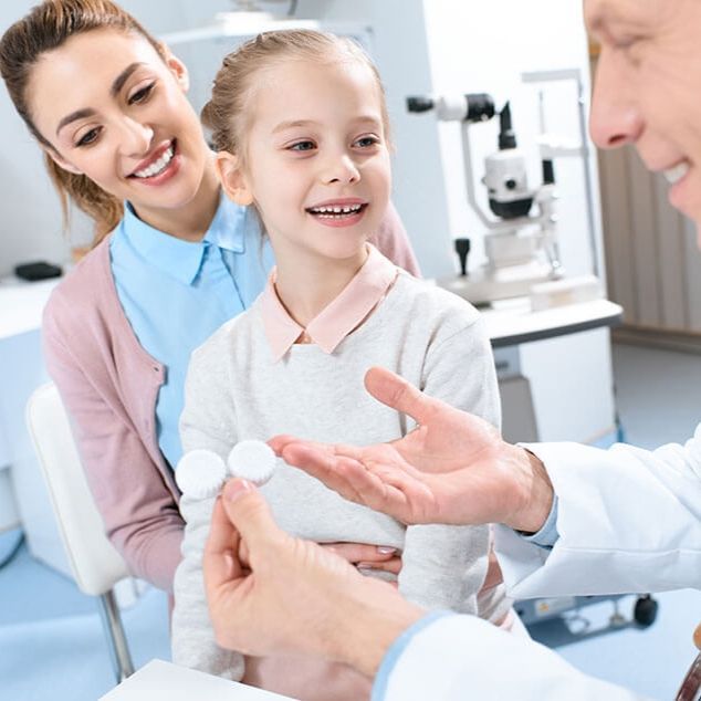A little girl is being examined by an ophthalmologist