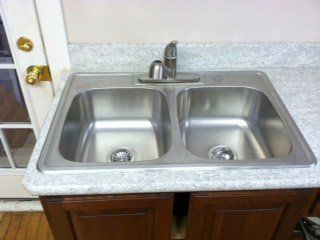 Kitchen Countertops Renovation — Stainless Sink on Marble Countertop in Syracuse, NY