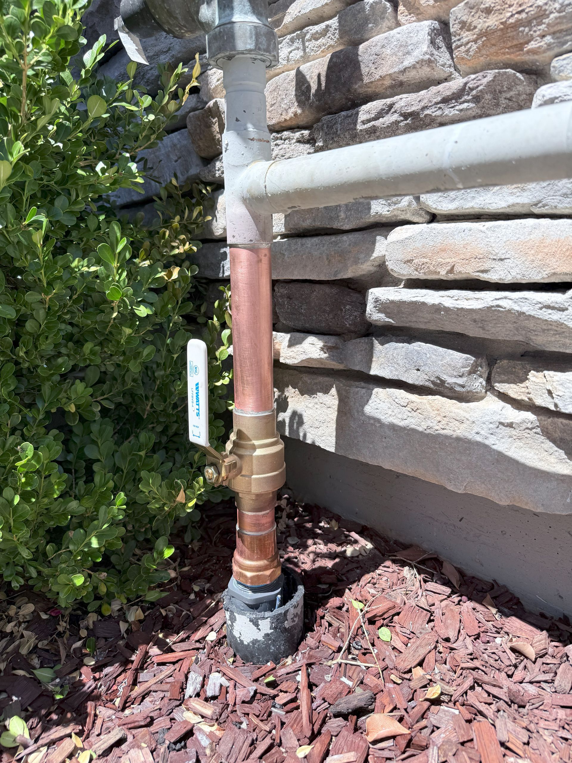 A copper pipe with a black device attached to it