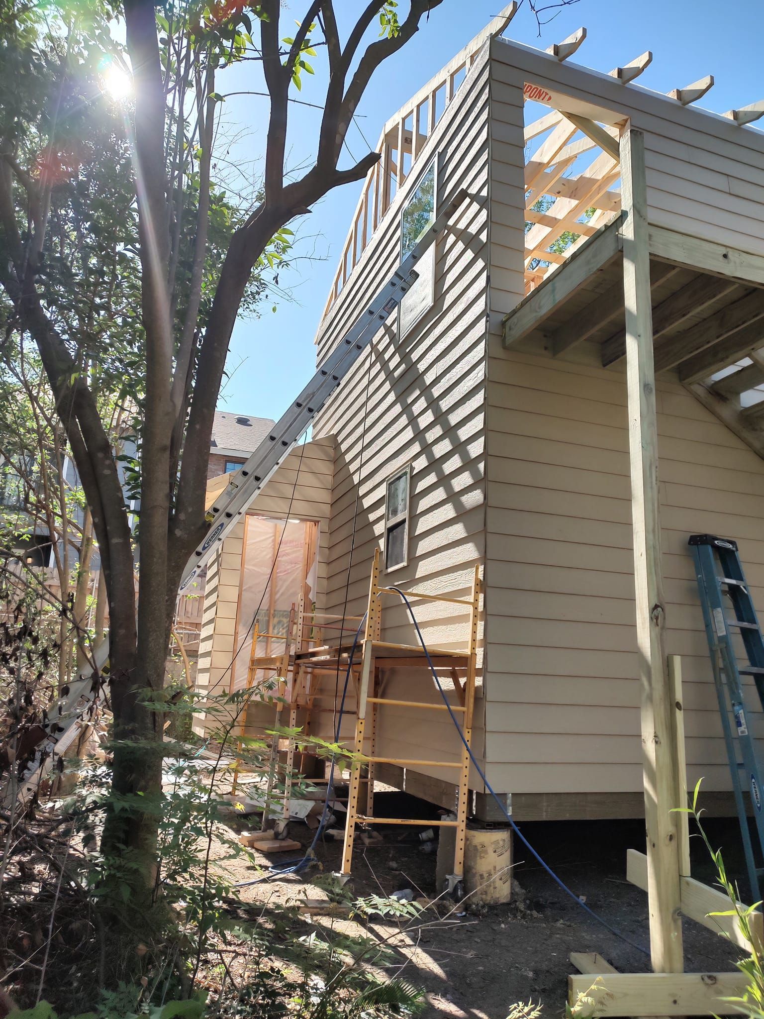 A house under construction with a ladder on the side of it