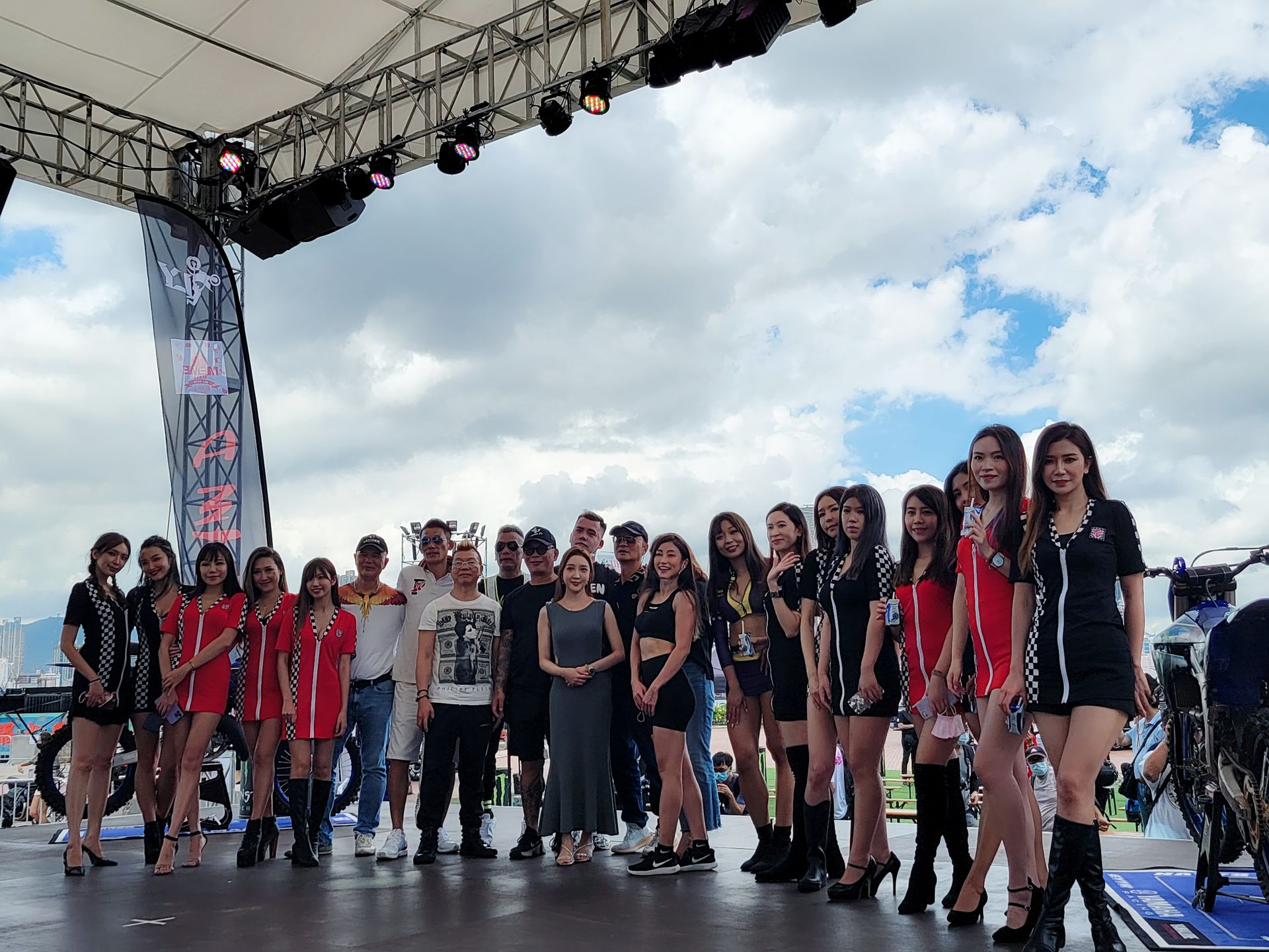 A group of people are posing for a picture on a stage.