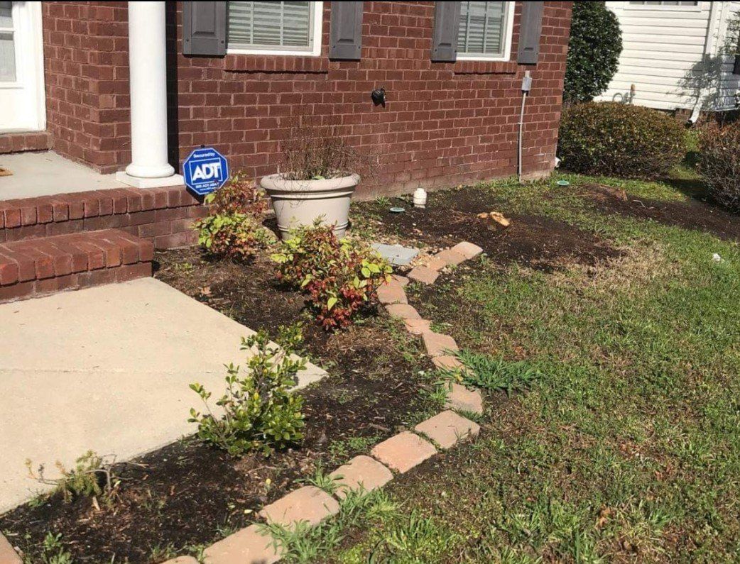 A brick house with a walkway in front of it