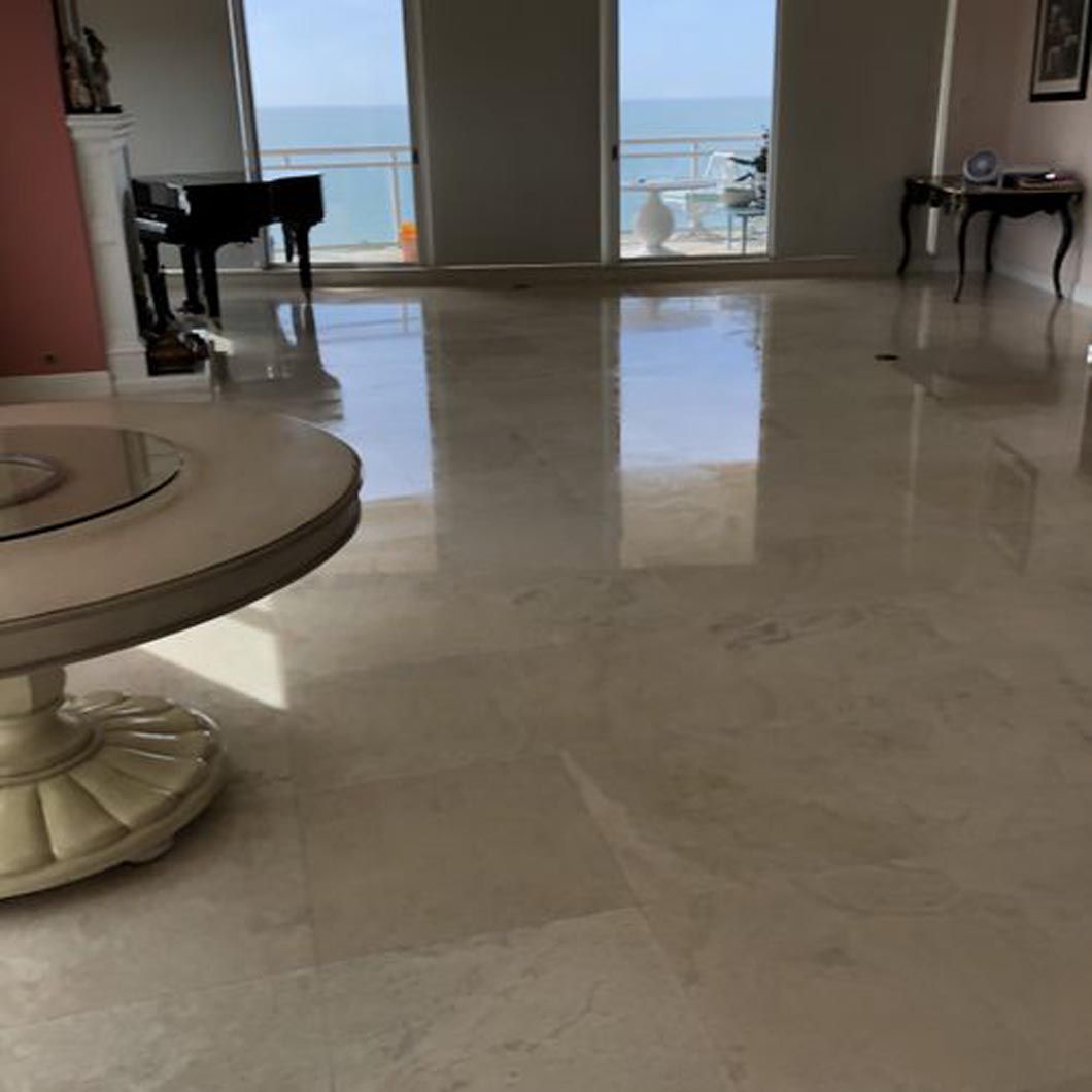 A living room with a round table and a piano.