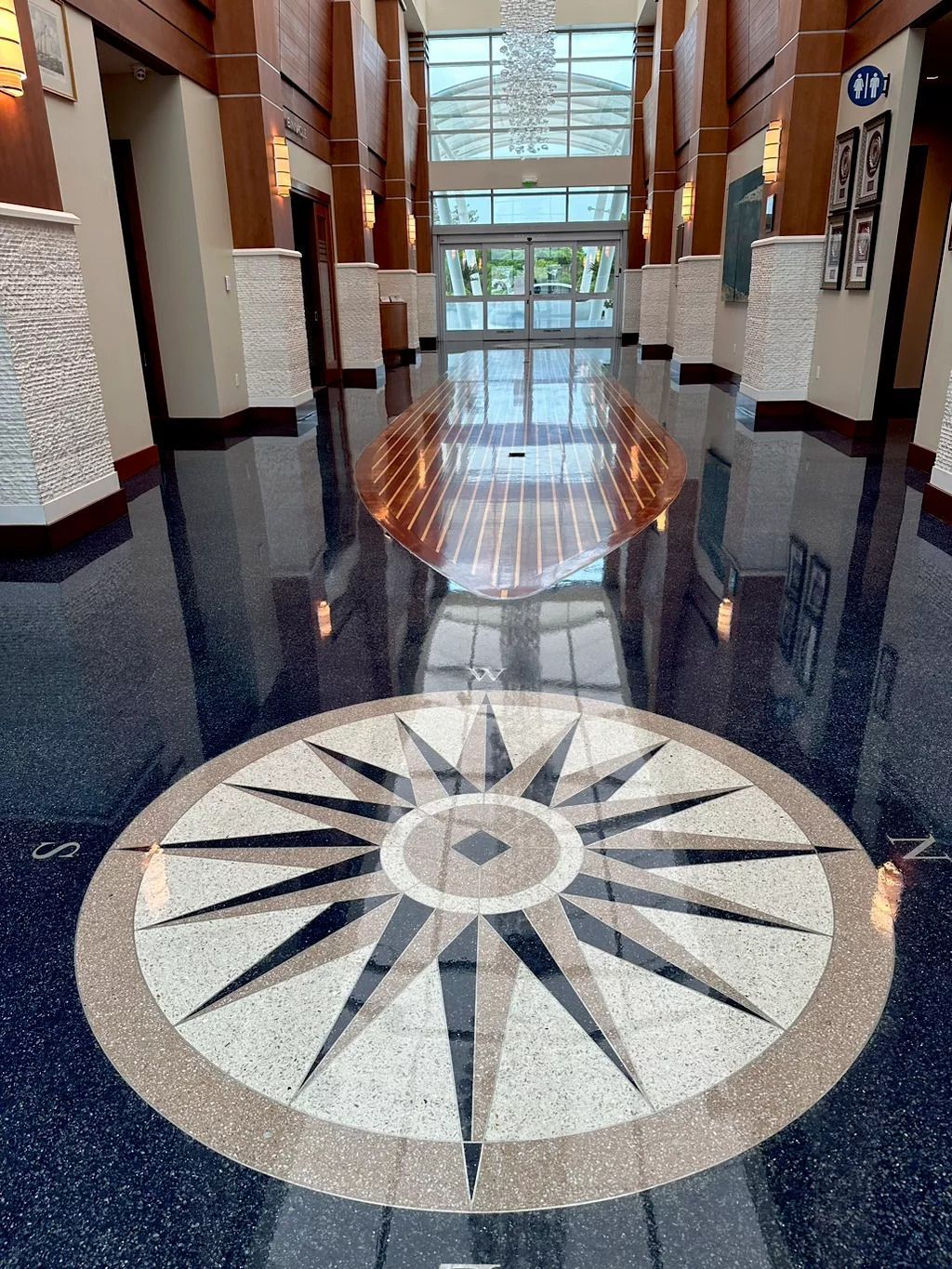 A large hallway with a circular design on the floor.