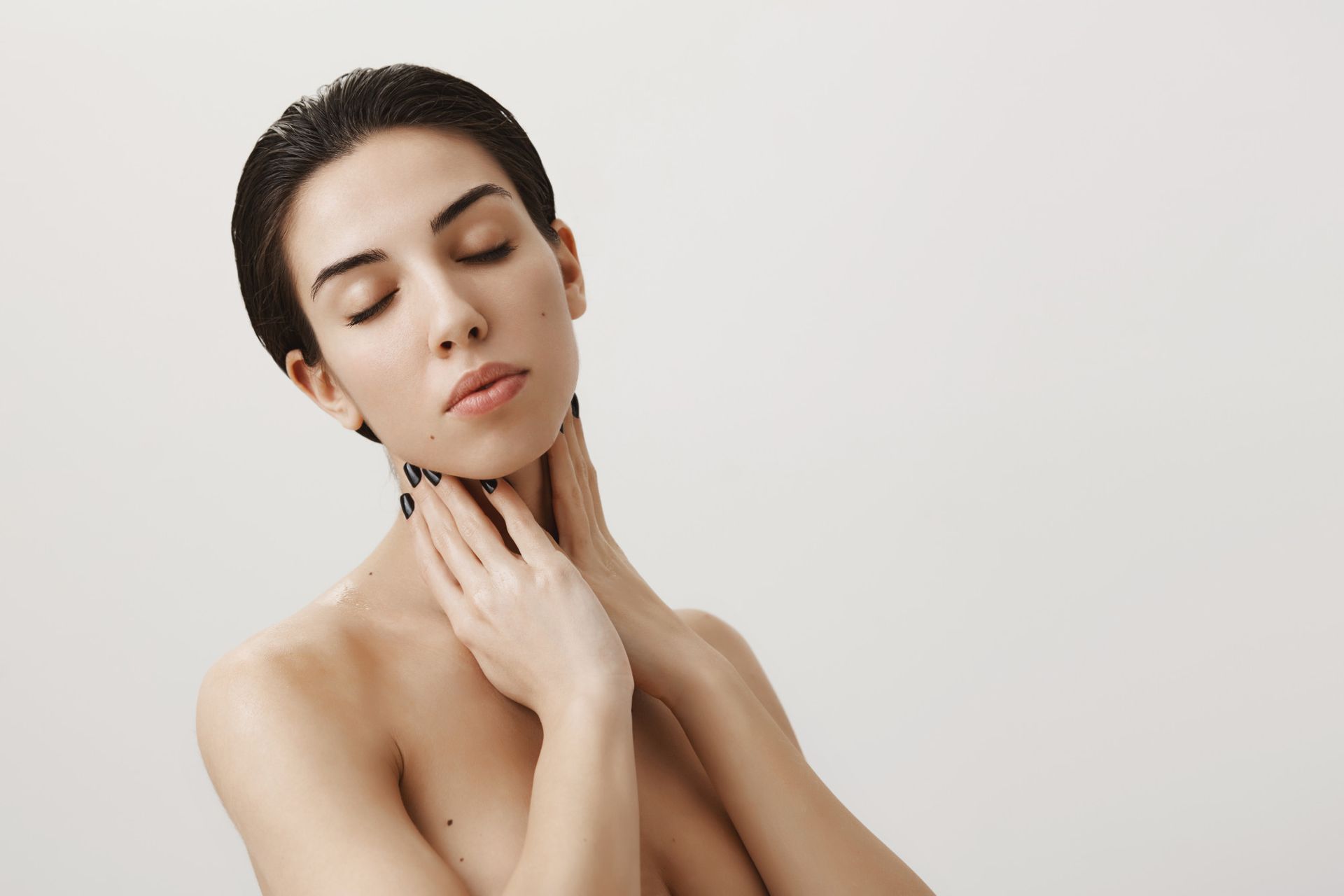 A woman touching her face with hands