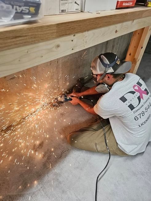 Person wearing safety glasses, cutting metal with a grinder, sparks flying.