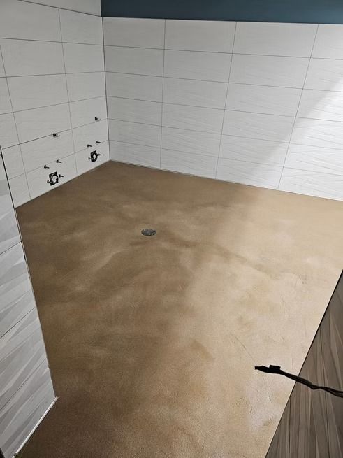 Bathroom with white tiled walls, tan floor, and blue accent wall.