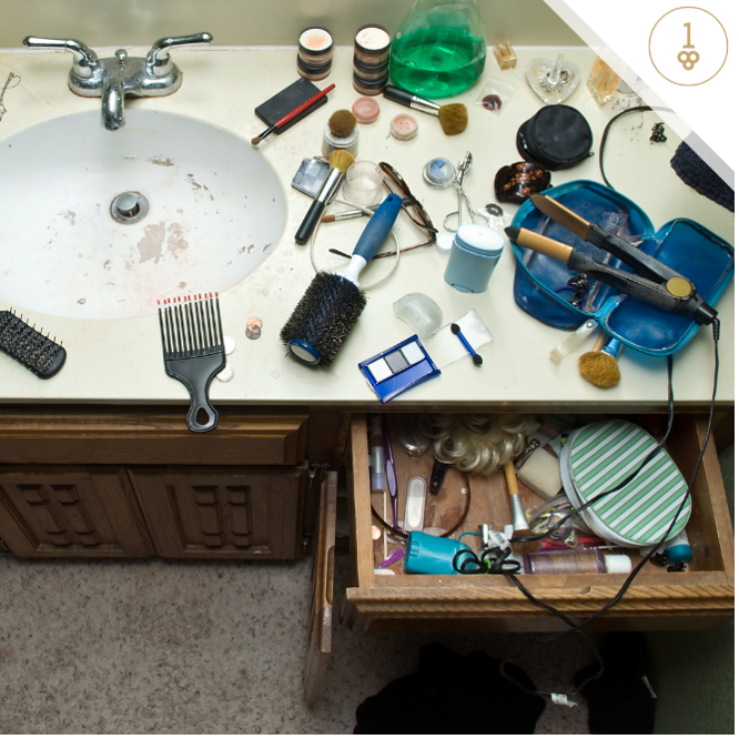 Bathroom with beauty tools scattered on vanity