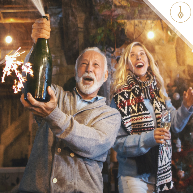 a man and a woman are celebrating with sparklers and champagne