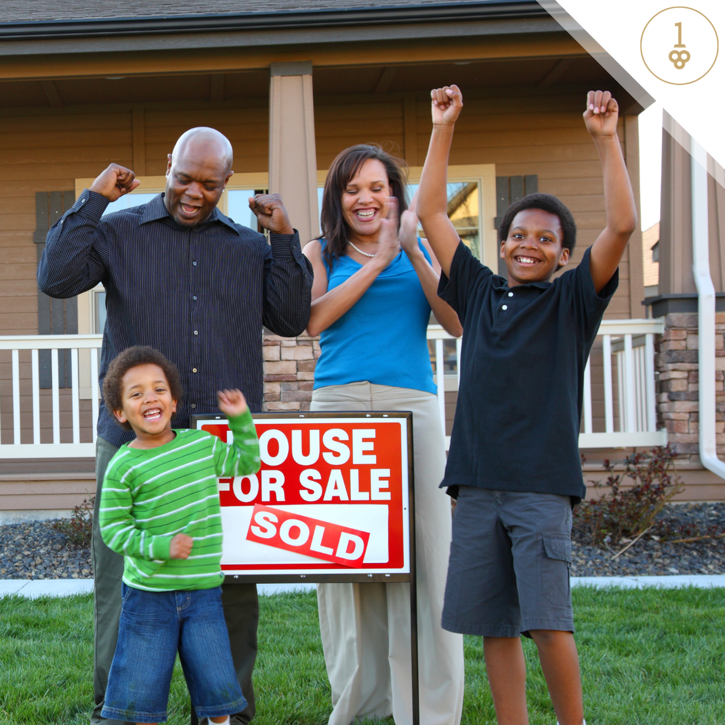 A family stands in front of a house for sale sign