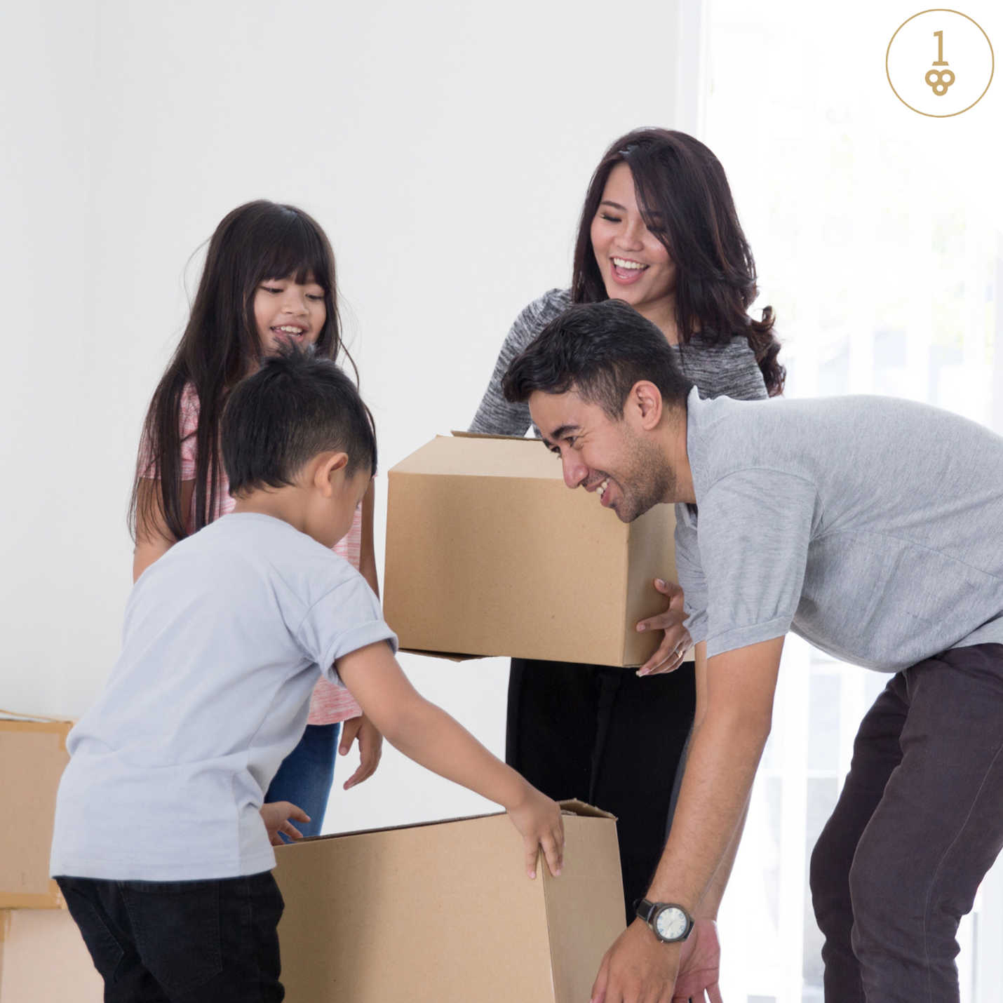A family is moving into a new home and holding cardboard boxes.