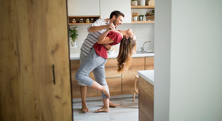 Young couple dancing in kitchen