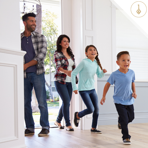 a family is walking down a hallway in their new home