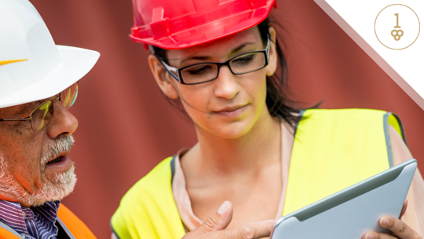 On-site construction workers looking at tablet