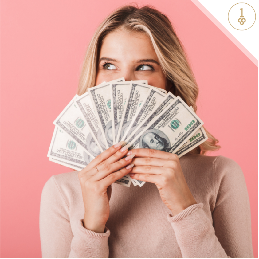 Woman holding money in front of her face