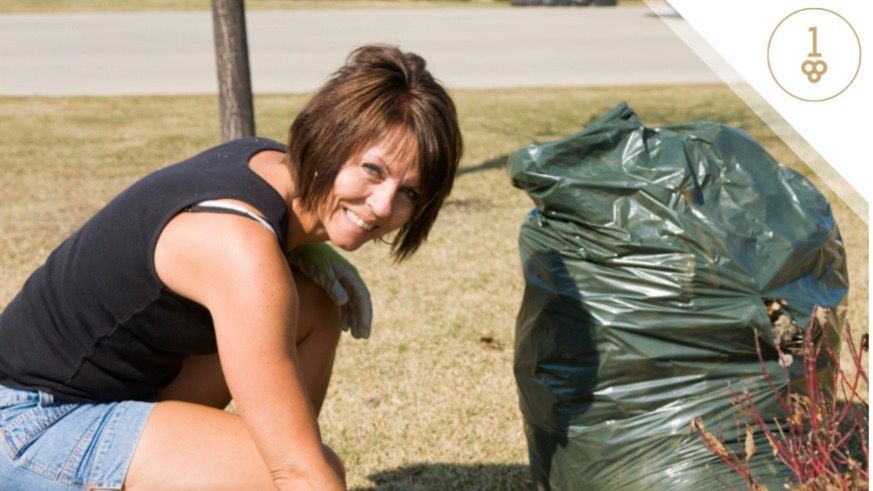 Woman picking up yard debris