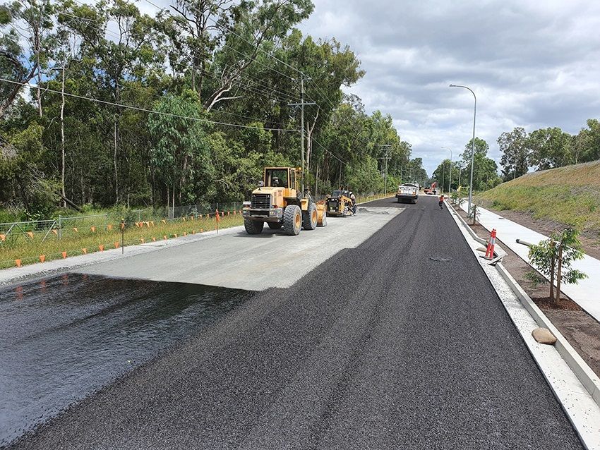 A Row of Tractors Are Sealing a Road — Cuzkell Pty. Ltd in Cooroy, QLD