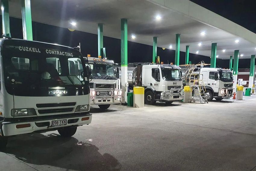 A Row of Trucks Are Parked in a Parking Lot at Night — Cuzkell Pty. Ltd in Chinchilla, QLD