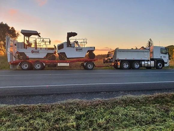 A Truck is Carrying a Machine on a Trailer on the Side of the Road — Cuzkell Pty. Ltd in Cooroy, QLD