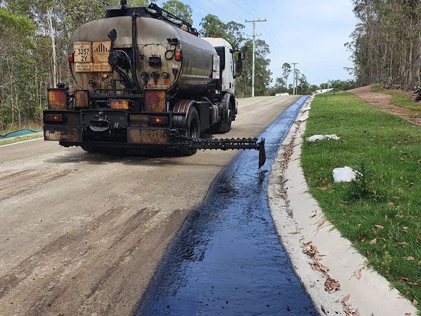 A Truck is Spraying Asphalt on the Side of a Road — Cuzkell Pty. Ltd in Cooroy, QLD