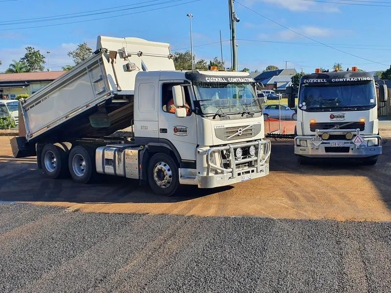 Two Dump Trucks Are Working on a Road — Cuzkell Pty. Ltd in Cooroy, QLD