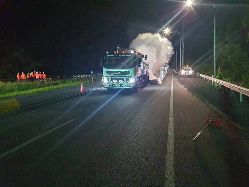 A Green Truck is Working on a Highway at Night — Cuzkell Pty. Ltd in Bundaberg, QLD