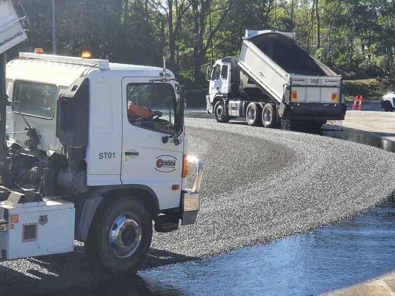 Two Trucks Are Dumping Gravel on a Road — Cuzkell Pty. Ltd in Cooroy, QLD