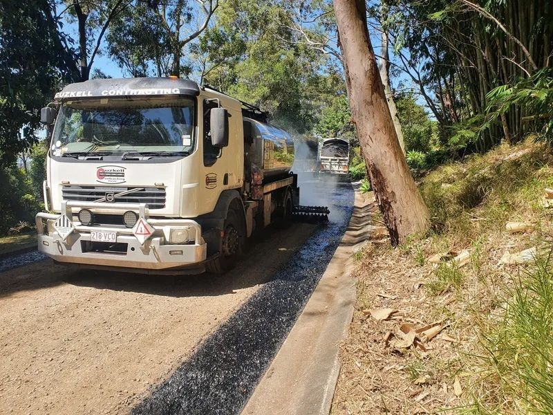 A Truck is Working on a Dirt Road Next to a Tree — Cuzkell Pty. Ltd in Cooroy, QLD