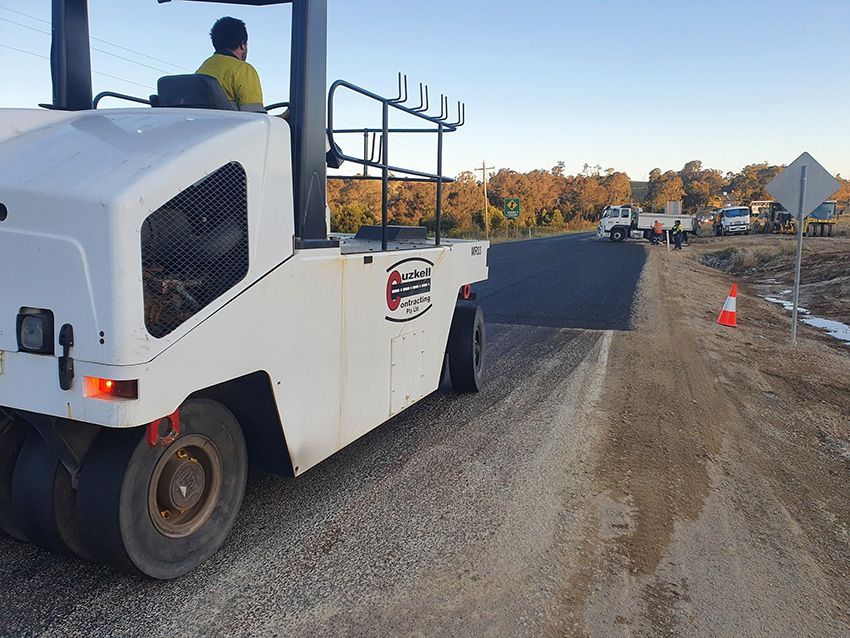 A White Truck is Driving Down a Dirt Road — Cuzkell Pty. Ltd in Dalby, QLD