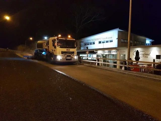A White Truck is Paving a Street at Night — Cuzkell Pty. Ltd in Cooroy, QLD