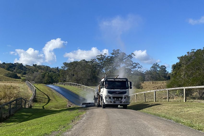 A White Truck is Dumping Gravel Down a Dirt Road — Cuzkell Pty. Ltd in Kingaroy, QLD